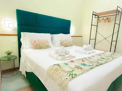 a bedroom with a large bed with towels on it at Accommodation in Rome near Termini Loft San Lorenzo in Rome