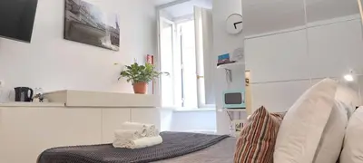 a white room with a bed and a window at Navona Cozy Apartment in Rome