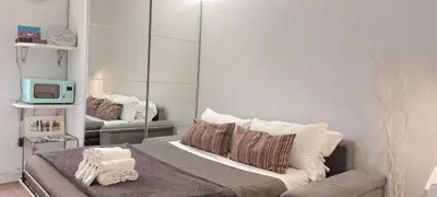 a room with a bed with a mirror and a tv at Navona Cozy Apartment in Rome