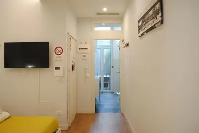 a hospital room with a bed and a tv on a wall at Navona Cozy Apartment in Rome