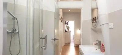 a white bathroom with a shower and a sink at Navona Cozy Apartment in Rome