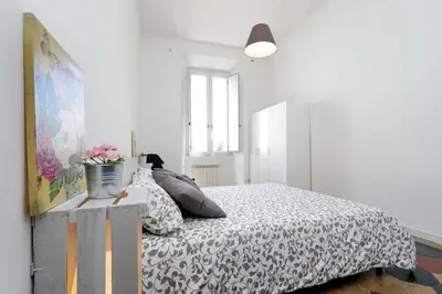 a white bedroom with a bed with pillows on it at Le Rondinelle di Trastevere in Rome