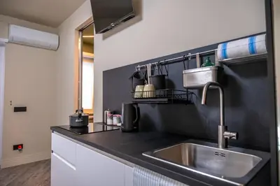 a kitchen with a sink and a black counter top at zampieri house camera verde in Rome