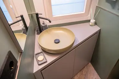 a bathroom with a bowl sink on a counter at zampieri house camera verde in Rome