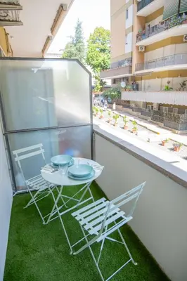 a small table and two chairs on a balcony at zampieri house camera verde in Rome