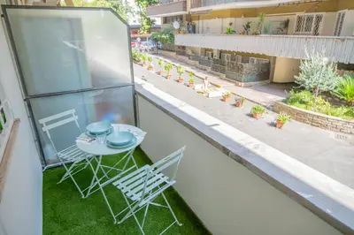an empty balcony with a table and chairs on it at zampieri house camera verde in Rome
