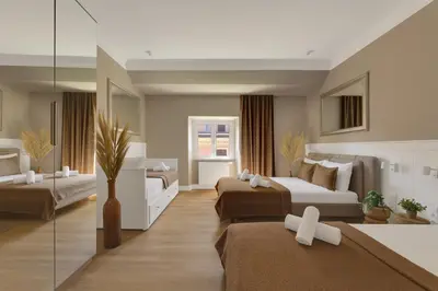 a hotel room with two beds and a mirror at ROME City Center Apartment IV in Rome