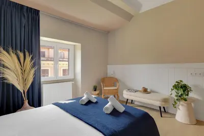 a bedroom with a bed with a blue blanket at ROME City Center Apartment IV in Rome