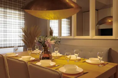 a dining room table with glasses and a vase with flowers at ROME City Center Apartment IV in Rome