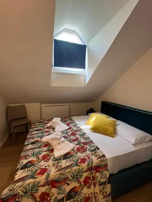 a bedroom with a bed with towels on it at Renewed Historic Flat in Rome in Rome