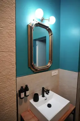 a bathroom with a white sink and a mirror at Renewed Historic Flat in Rome in Rome