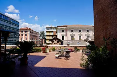 a courtyard with tables and chairs in a city at Renewed Historic Flat in Rome in Rome