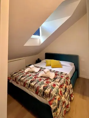 a bedroom with a bed with towels on it at Renewed Historic Flat in Rome in Rome
