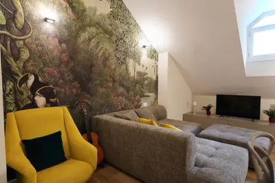 a living room with a couch and a painting on the wall at Renewed Historic Flat in Rome in Rome