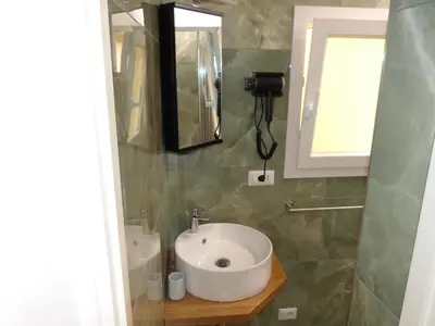 a bathroom with a white sink and a mirror at The column of Campo de' Fiori in Rome