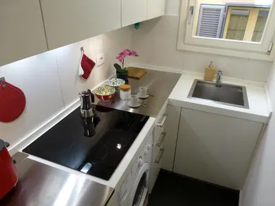 a small kitchen with a sink and a stove at The column of Campo de' Fiori in Rome
