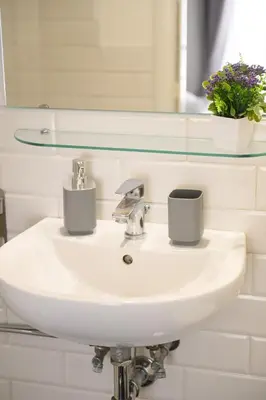 a bathroom sink with two cups on it at Lovely apartment in the City Centre in Rome