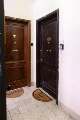 two large wooden doors in a room with tiles at Lovely apartment in the City Centre in Rome