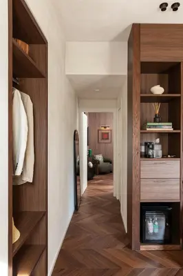 a hallway with wood floors and a room with a fireplace at NAMAN HOTELLERIE - Condotti in Rome