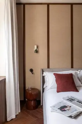 a hotel room with a bed with a newspaper on it at NAMAN HOTELLERIE - Condotti in Rome