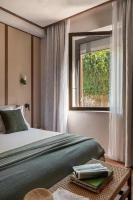 a bedroom with a bed and a window at NAMAN HOTELLERIE - Condotti in Rome