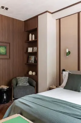 a bedroom with a bed and a chair at NAMAN HOTELLERIE - Condotti in Rome