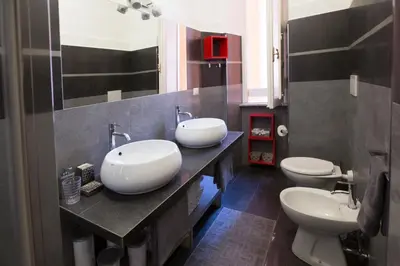 a bathroom with two sinks and two toilets at Roma San Peter Suite in Rome