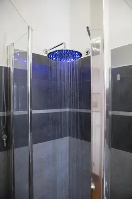 a shower with a blue shower in a bathroom at Roma San Peter Suite in Rome