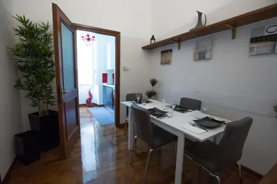 a dining room with a white table and chairs at Roma San Peter Suite in Rome