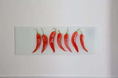 a row of chili peppers on a white wall at Roma San Peter Suite in Rome