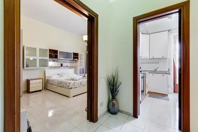 a bedroom with a bed and a large mirror at Karolina's Home, 2-BDR at Vatican in Rome