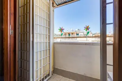 a room with a view of the city from a balcony at Karolina's Home, 2-BDR at Vatican in Rome