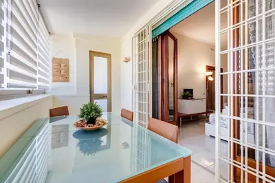 a dining room with a glass table and chairs at Karolina's Home, 2-BDR at Vatican in Rome