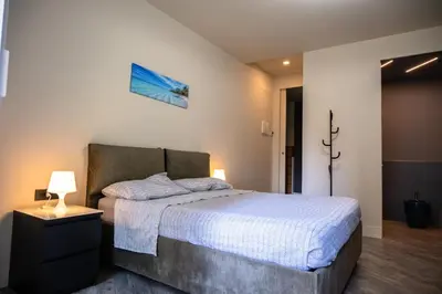 a bedroom with a bed and a lamp on a table at zampieri house camera blu in Rome