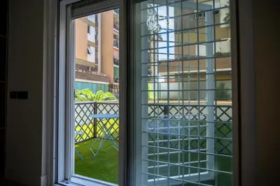 a window with a view of a balcony at zampieri house camera blu in Rome