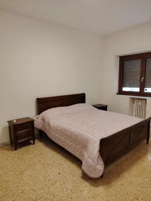 a bedroom with a large bed and a window at Anna Roma House 2 in Rome