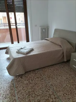a bed in a room with a large window at Anna Roma House 2 in Rome