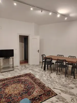 a room with a table and chairs and a tv at Anna Roma House 2 in Rome