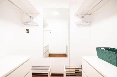 a room with white walls and a mirror at Persia Collection Ripetta in Rome