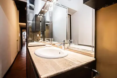a bathroom with a sink and a mirror at Persia Collection Ripetta in Rome