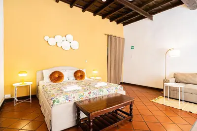 a bedroom with a bed with a table and a couch at Persia Collection Ripetta in Rome