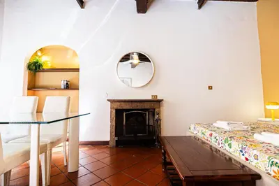 a living room with a table and a fireplace at Persia Collection Ripetta in Rome