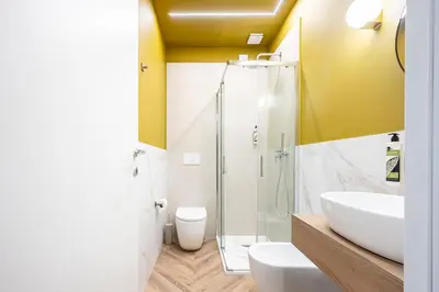 a bathroom with a shower and a toilet and a sink at Bea Boutique Hotel in Rome