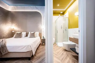 a bedroom with a bed and a bathroom with a shower at Bea Boutique Hotel in Rome