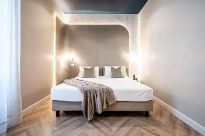 a bedroom with a large bed with white sheets at Bea Boutique Hotel in Rome