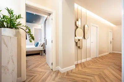 a hallway with a door leading to a room with a bed at Bea Boutique Hotel in Rome