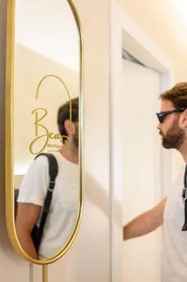a man standing in front of a mirror at Bea Boutique Hotel in Rome