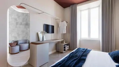 a bedroom with a bed and a desk at Bea Boutique Hotel in Rome