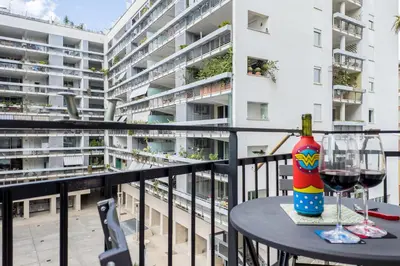 a table with a bottle of wine and glasses on a balcony at Lungotevere Bijou with Private Balcony in Rome