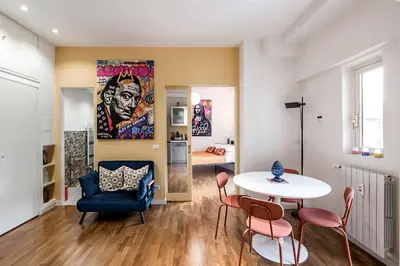 a living room with a table and chairs at Lungotevere Bijou with Private Balcony in Rome